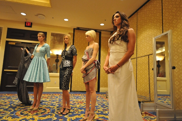 From left, Jamie Grover, Alexandra Zevalking, Rachel Moore and Katelyn Koval are fitted in dresses created by students in the fashion program at the International Academy of Design & Technology. T ...