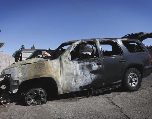 A burned-out vehicle is seen in a City of Henderson lot in Henderson on Monday.
