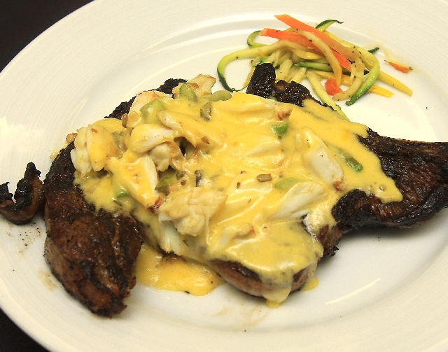 A 22-ounce, wet-aged, bone-in rib-eye steak done Oscar style, with bearnaise sauce, crabmeat and asparagus can be found at Oscar’s Beef, Booze & Broads.