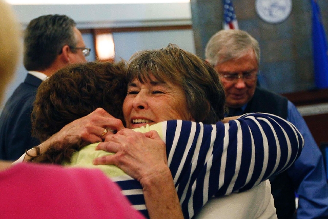 Bonnie Brunson, middle, hugs friend Robyn Sedillos after a jury decision. Her husband, Carl, is on the right.