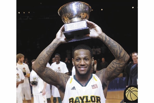 Pierre Jackson holds the most valuable player trophy after the NIT championship game against Iowa on Thursday. Baylor won 74-54.