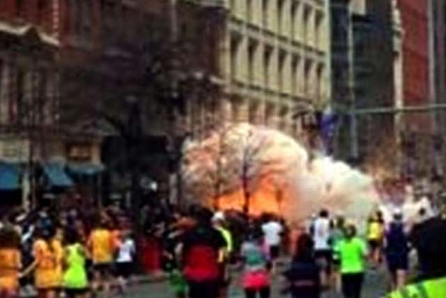 In this image from video provided by WBZ TV, spectators and runners run from what was described as twin explosions that shook the finish line of the Boston Marathon on Monday in Boston. Two explos ...