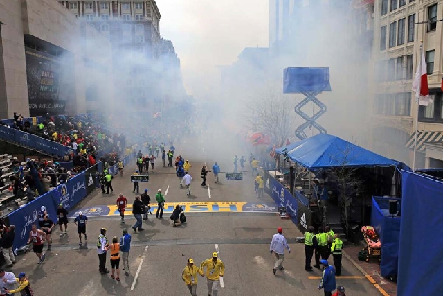 Medical workers aid injured people at the 2013 Boston Marathon following an explosion in Boston on Monday.