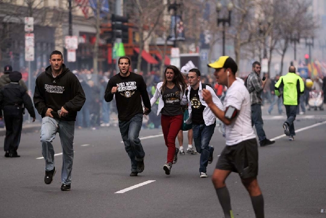People react to an explosion at the 2013 Boston Marathon in Boston on Monday.