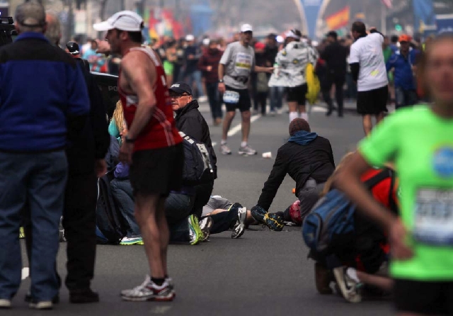 People react to an explosion at the 2013 Boston Marathon on Monday.