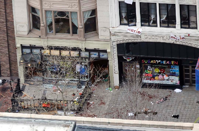 Debris is spread along the sidewalk of one of the blast sites on Boylston Street near the finish line of the 2013 Boston Marathon in the wake of two blasts in Boston on Monday.