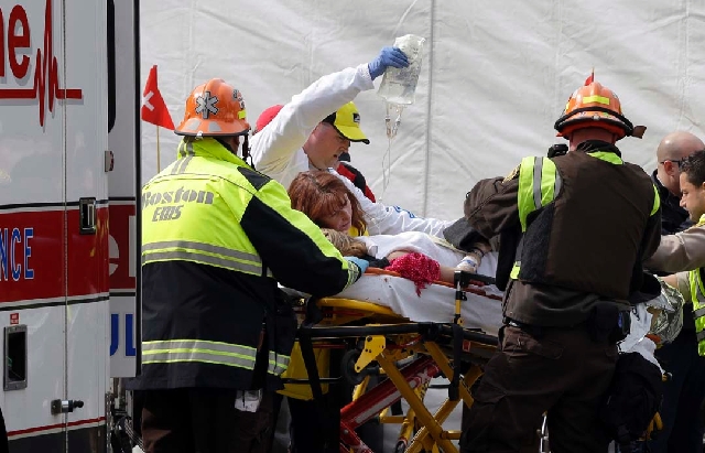 An injured person is loaded into an ambulance in the aftermath of two blasts near the finish line of the Boston Marathon on Monday. Two bombs exploded, killing two people and injuring many more. A ...