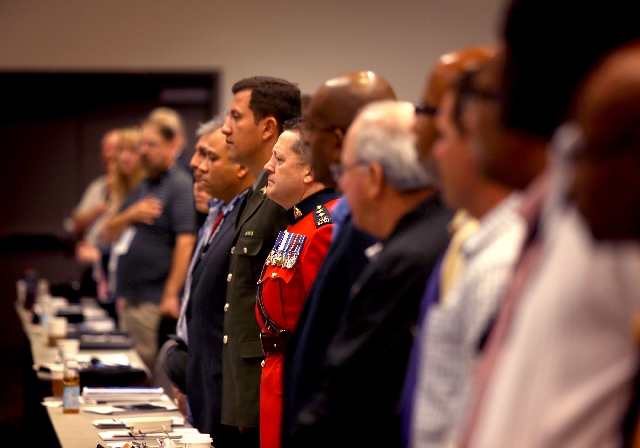Security personnel stand during the playing of the national anthem on April 23 at the Tourism Safety Conference at the Las Vegas Convention Center. Stephen O'Grady of logistics business ED Service ...