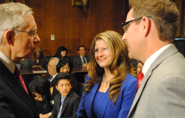 Jennifer Dorsey, a partner at the Las Vegas firm of Kemp, Jones & Coulthard and her husband Daron Dorsey, right, are greeted by Sen. Harry Reid, D-Nev. The Senate Judiciary Committee voted along p ...