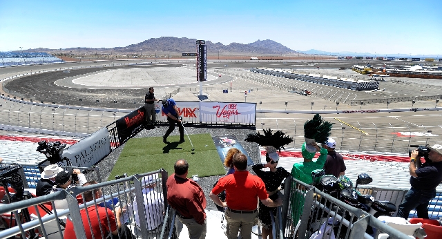 The tri-oval at Las Vegas Motor Speedway provides a scenic backdrop as Ryan Winther, the 2012 RE/MAX World Long Drive Champion, tees off from the Dale Earnhardt Terrace on Thursday during a news c ...