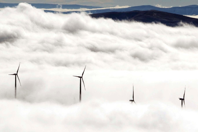 Wind turbines at the Vantage Wind Farm stand above the clouds at Vantage, Wash.  Renewable energy is derived from renewable sources such as wind, solar, geothermal or plant matter. This type of en ...