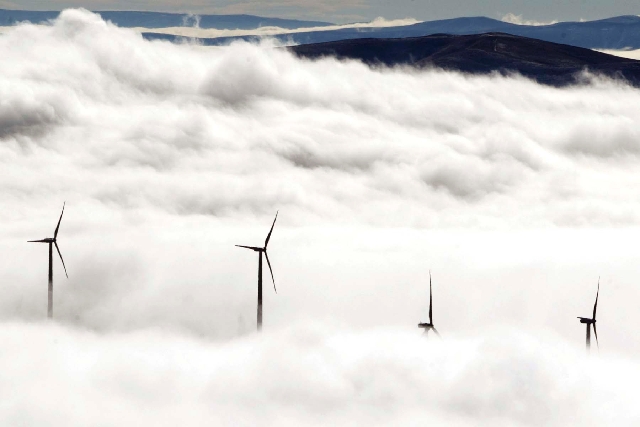 Wind turbines at the Vantage Wind Farm stand above the clouds at Vantage, Wash. Renewable energy is derived from renewable sources such as wind, solar, geothermal or plant matter. This type of en ...