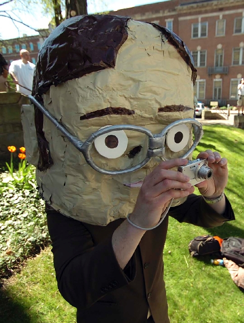 Chris Sedlak of Dayton, Ohio wears a large bobble head mask depicting "The Office" character Dwight Schrute portrayed by actor Rainn Wison on Saturday in downtown Scranton, Pa., during "The Office ...
