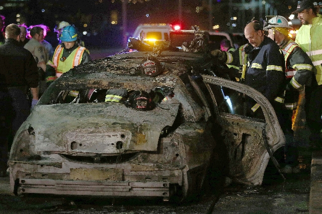 San Mateo County firefighters and California Highway Patrol personnel investigate the scene of a limousine fire on the westbound side of the San Mateo-Hayward Bridge in Foster City, Calif., on Sat ...