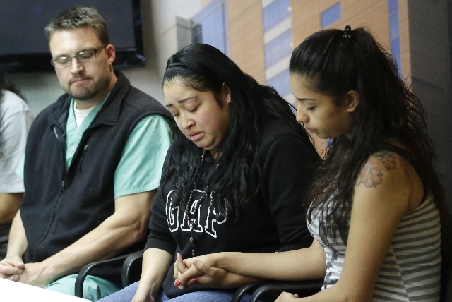 Johana Portillo, center, and her sister Ana Portillo hold hands while Dr. Shawn Smith looks on during a news conference at Intermountain Medical Center, in Murray, Utah. Ricardo Portillo, a Utah s ...