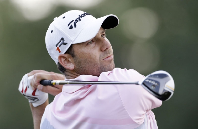 Sergio Garcia hits from the 16th tee Sunday during the third round of The Players championship golf tournament. Garcia claims that Tiger Woods created a disturbance when Garcia was playing a shot ...