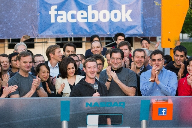 Facebook founder, Chairman and CEO Mark Zuckerberg, center, rings the opening bell of the Nasdaq stock market, from Facebook headquarters in Menlo Park, Calif on May 18, 2012.