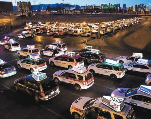 Taxis wait to pick up passengers March 1 at McCarran International Airport. A Legislative Counsel Bureau audit report published in April recommended an overhaul for how medallions, the operating p ...
