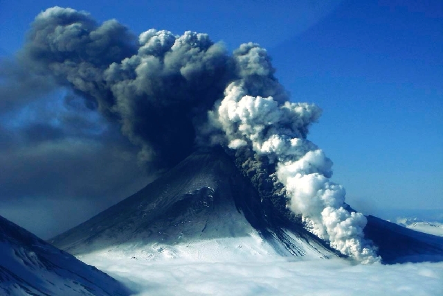 In this photo provided by the Alaskan Volcano Observatory, the Pavlof volcano erupts Thursday , as seen from the air from the southwest in Cold Bay, Alaska.