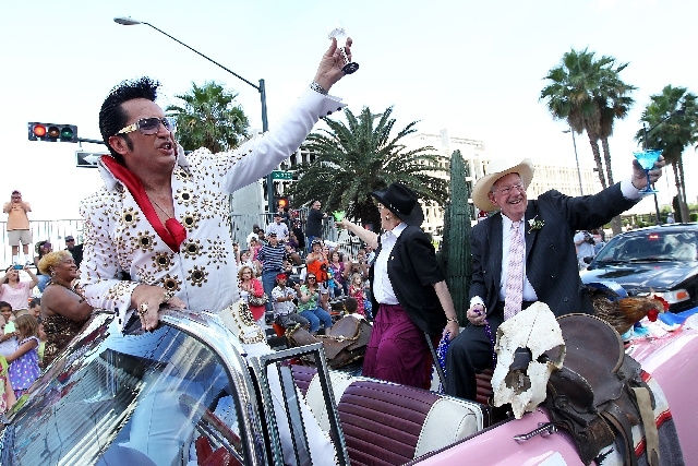 Jesse "Elvis" Garon, along with Mayor Carolyn Goodman and her husband, former Mayor Oscar Goodman, toast the crowd Saturday during the annual Helldorado Days Parade in downtown Las Vegas. Helldora ...