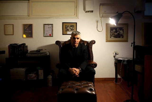 Yair Lapid, popular former TV anchorman and head of the new centrist party Yesh Atid, poses for a portrait at his house during an interview for the Associated Press, in Tel Aviv, Israel. Lapid, Pr ...