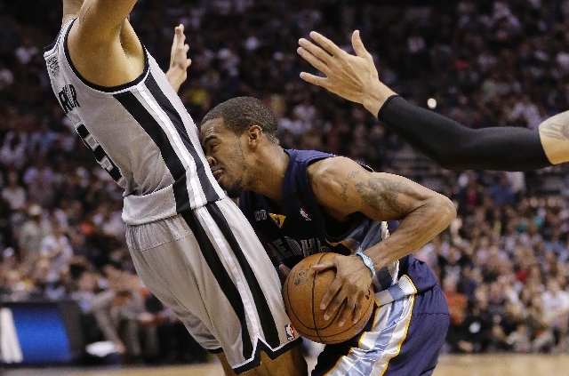 Memphis Grizzlies' Mike Conley, right, crashes into San Antonio Spurs' Tony Parker (9), of France, during the second half in Game 1 of a Western Conference Finals NBA basketball playoff series on ...