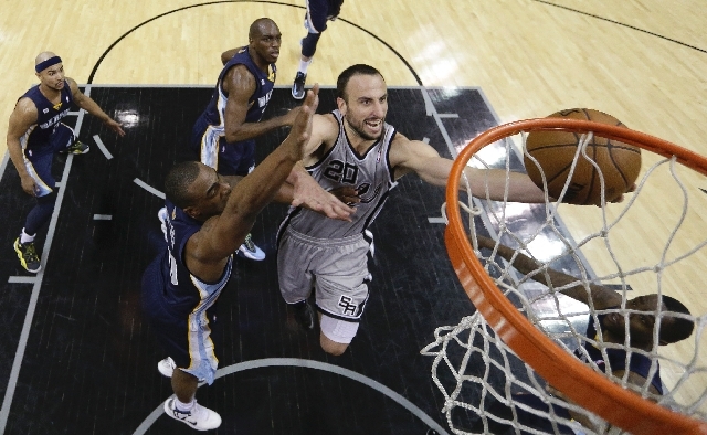 San Antonio Spurs' Manu Ginobili (20), of Argentina, drives to the basket as Memphis Grizzlies' Darrell Arthur, left, defends him during the second half in Game 1 of a Western Conference Finals NB ...