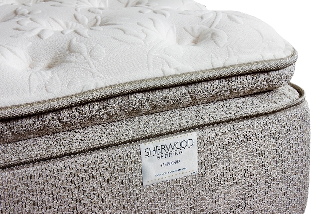 With a pillowtop and luxurious, patterned ticking, the exterior of a Sherwood Bedding hybrid mattress looks comfortable. Experts, however, recommend lying on the bed for at least five minutes to t ...