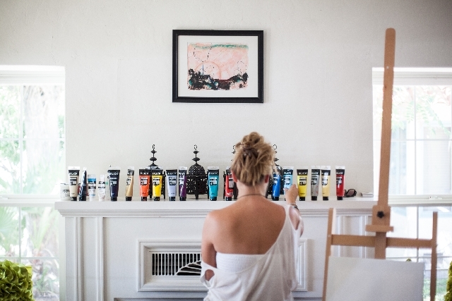 Kelly McCabe chooses paints for her self-portrait at the "You Are Your Own Muse" retreat.