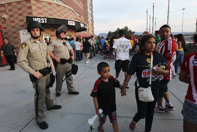 Police in riot gear stand at the ready before the start of the game between Club America and Chivas at Sam Boyd Stadium in Las Vegas on Wednesday.
