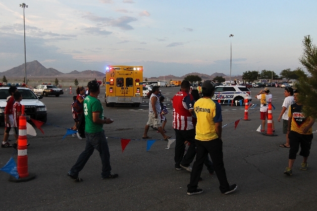 Fans walk past an ambulance after a fight broke out before the start of the game between Club America and Chivas at Sam Boyd Stadium in Las Vegas on Wednesday.