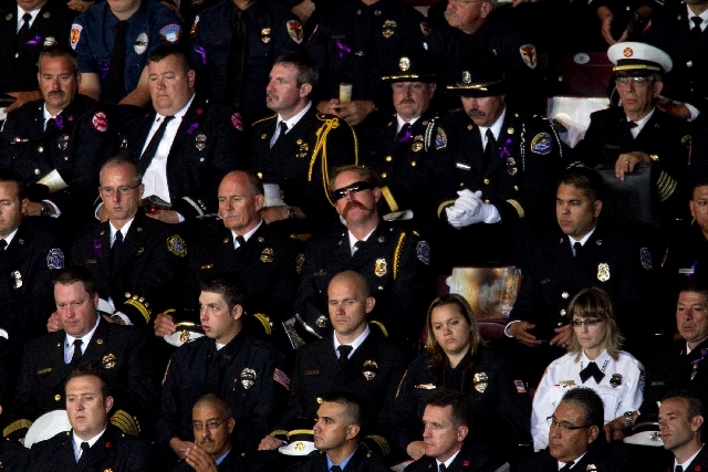 Firefighters listen during the "Our Fallen Brother" memorial service for the 19 fallen firefighers at Tim's Toyota Center in Prescott Valley, Ariz. on Tuesday. Prescott's Granite Mountain Hotsho ...