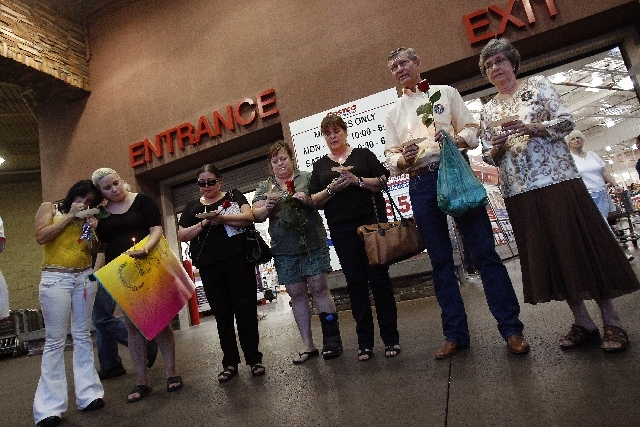 Linda Scott, right, and her husband Bill Scott, second from right, attend a vigil for Erik Scott at the Summerlin Costco in Las Vegas Wednesday. Erik Scott, son of Bill and Linda Scott, was killed ...