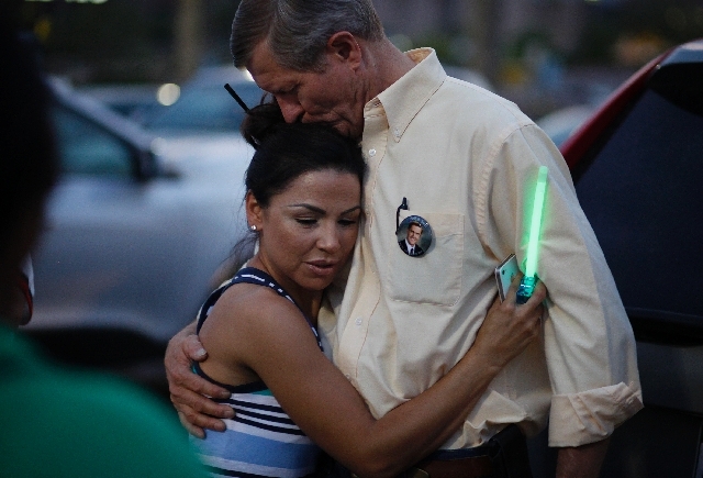 Violet Abreo-Frear, left, hugs Bill Scott at during a vigil for Erik Scott at the Summerlin Costco on Wednesday. Erik Scott, son of Bill Scott, was killed by Las Vegas police three years ago at th ...
