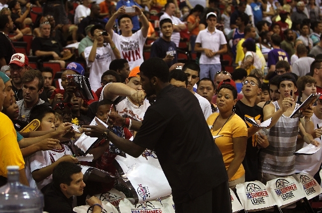 Fans flock to get Cleveland's Kyrie Irving's autograph during the NBA Summer League at the Cox Pavilion in Las Vegas on Friday.