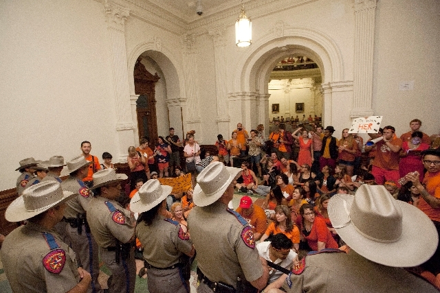 Abortion rights advocates protest HB2 from the area outside of the Senate Chamber in the State Capitol in Austin, Texas on Friday night.