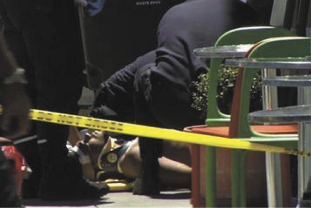 In this frame grab from video, emergency personnel tend to an injured man after a shooting outside a shopping center in San Francisco on Friday. Two women were killed and a man was wounded on Frid ...
