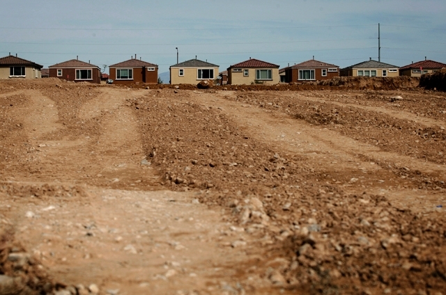 Homes are seen behind land being graded at Serenada by Harmony Homes on March 25.