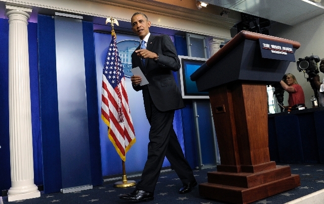 President Barack Obama walks from the podium after speaking about the death of Trevyon Martin at the beginning of the daily White House briefing in the Briefing Room of the White House in Washingt ...