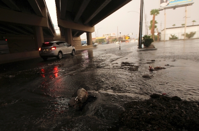 A flash flood spills onto Bonanza Road as thunderstorms roll over the Las Vegas Valley on Friday.