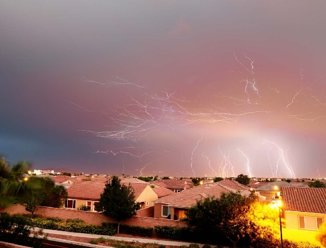 Lightning strikes fracture the clouds in this long exposure photographed by Robert Pernett in Northwest Las Vegas. The storm rolled in from the northeast and marched across the valley, dumping rai ...