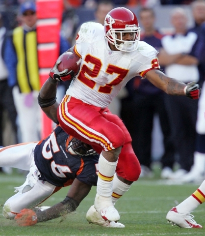 Kansas City Chiefs running back Larry Johnson (27) breaks a tackle from Denver Broncos linebacker Al Wilson (56) during the fourth quarter of a football game in Denver on Sept. 17, 2006. Johnson s ...