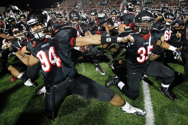 In this Dec. 3, 2010 file photo, Trinity High School football players Polo Manukainiu (94) and Paul Tuipulotu (35) perform a "Haka" with the team before a game against Coppell in Southlake, Texas ...
