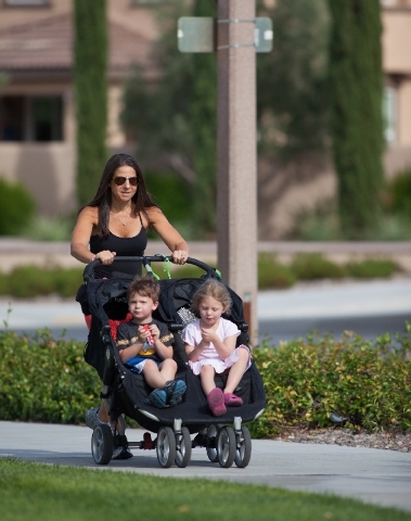 Andrea Behrens exercises by taking a walk with her children Emma, 5, and Noah, 3, at South Tower Park. She wants to be a role model in encouraging her youngsters to embrace healthful eating and ex ...