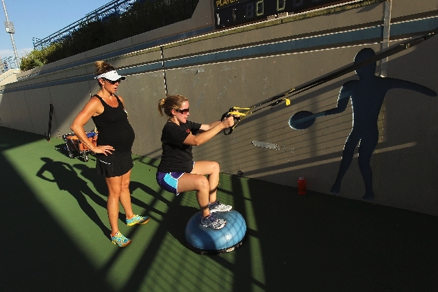 Las Vegas Bootcamp co-founder and trainer Kerry Geyser, left, works with client Vanessa Baur during a private, pregnancy-based session at the Darling Tennis Center in Las Vegas. Geyser, an experie ...