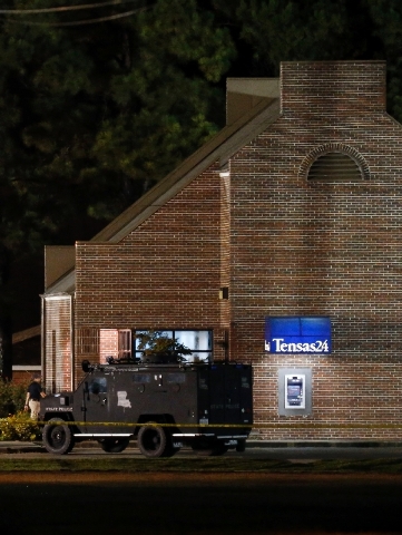A SWAT vehicle sits outside the Tensas State Bank in St. Joseph, La., as investigators work throughout the early morning hours Wednesday at the bank where a gunman took three people hostage Tuesda ...