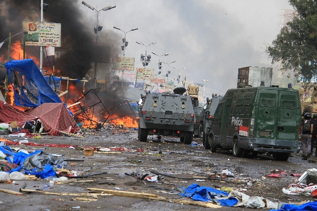 Egyptian security forces clear a sit-in by supporters of ousted President Mohammed Morsi in Cairo on Wednesday.