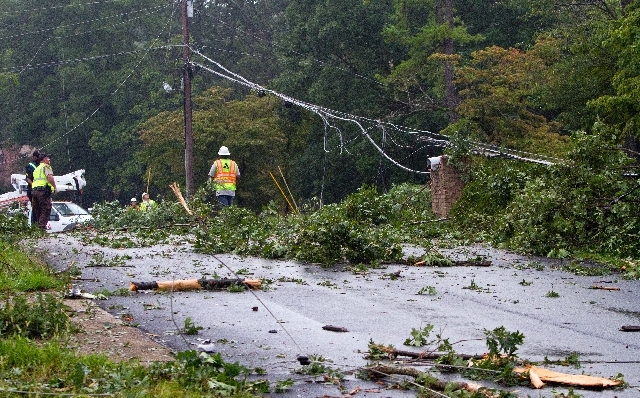 Fire crews assess damage on a street where a UPS cargo plane knocked down trees and power lines as it crashed early Wednsday morning near Birmingham-Shuttlesworth International Airport in Birmingh ...