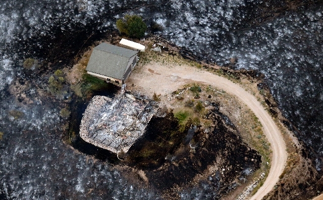 Blackened landscape surrounds the ashes of one of the homes destroyed  by the wildfire in an aerial view made Wednesday morning near Rockport, Utah.