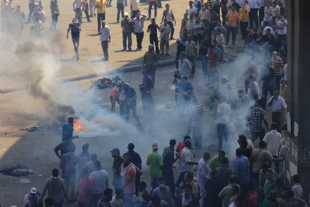 Supporters of ousted President Mohammed Morsi clash with Egyptian security forces Wednesday in Cairo.